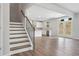 Open-concept living room with hardwood floors, staircase, and access to the kitchen at 6934 Melody Ridge Rd, Buford, GA 30518