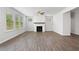 Bright living room featuring wood-look flooring, a ceiling fan, and a fireplace with a decorative mantel at 6934 Melody Ridge Rd, Buford, GA 30518