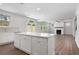 Open concept living area with kitchen island, fireplace, and access to the backyard at 6934 Melody Ridge Rd, Buford, GA 30518