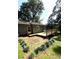 Backyard features a wooden deck, lawn, garden, and a fenced boundary for privacy at 205 Trickum Hills Ln, Woodstock, GA 30188