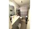 Neutral bathroom featuring a vanity, toilet, and tub/shower combination with a patterned shower curtain at 205 Trickum Hills Ln, Woodstock, GA 30188