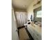Compact bathroom featuring a shower with patterned curtain and a single sink vanity at 205 Trickum Hills Ln, Woodstock, GA 30188