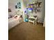 Playful room with a decorated corner shelf, featuring soft carpeting and playful decor at 205 Trickum Hills Ln, Woodstock, GA 30188