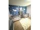 Bedroom featuring two gray cribs and an ocean mural at 205 Trickum Hills Ln, Woodstock, GA 30188