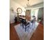 Bright dining area featuring a wooden table and a light-colored decorative rug at 205 Trickum Hills Ln, Woodstock, GA 30188