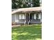 Charming front porch with white railings, columns, and steps leading to the front door at 205 Trickum Hills Ln, Woodstock, GA 30188