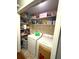 Well-organized laundry room with washer, dryer, and shelving for storage at 205 Trickum Hills Ln, Woodstock, GA 30188