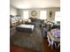 Cozy living room with comfortable grey sectional, ottomans, and natural light at 205 Trickum Hills Ln, Woodstock, GA 30188