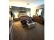 Cozy main bedroom with a decorative headboard and neutral accents at 205 Trickum Hills Ln, Woodstock, GA 30188