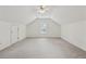 Carpeted attic featuring a ceiling fan and natural light. This space can be used as an extra bedroom or office at 240 Old Plantation Way, Fayetteville, GA 30214