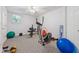 A clean and well lit basement with a ceiling fan with exercise equipment at 240 Old Plantation Way, Fayetteville, GA 30214