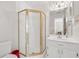 Bathroom featuring glass shower, white cabinets and sink, and a red trash can at 240 Old Plantation Way, Fayetteville, GA 30214