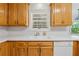 Kitchen featuring oak cabinets, white countertops, and stainless steel sink at 240 Old Plantation Way, Fayetteville, GA 30214