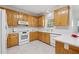 Bright kitchen featuring wooden cabinets, white countertops, and modern appliances at 240 Old Plantation Way, Fayetteville, GA 30214