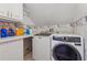 Functional laundry room with modern washer and dryer, counter space, and upper cabinets at 240 Old Plantation Way, Fayetteville, GA 30214