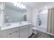 Modern bathroom with white vanity, large mirror, and shower-tub combo, providing a clean and functional space at 3554 Bluebird Ct, Atlanta, GA 30331