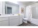 Bright bathroom featuring white cabinetry, shower with floral curtains at 3554 Bluebird Ct, Atlanta, GA 30331