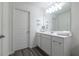 Bright bathroom featuring a white vanity, modern lighting, and a large mirror at 3554 Bluebird Ct, Atlanta, GA 30331