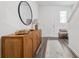 Bright foyer with wood-look flooring, wooden console and decorative mirror at 3554 Bluebird Ct, Atlanta, GA 30331
