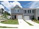 Two-story townhome features a one-car garage and manicured lawn at 3554 Bluebird Ct, Atlanta, GA 30331