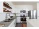 Stainless steel appliances, white cabinets, and subway tile backsplash in kitchen at 3554 Bluebird Ct, Atlanta, GA 30331