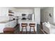 Modern kitchen with white cabinetry, stainless steel appliances, and island seating at 3554 Bluebird Ct, Atlanta, GA 30331