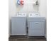 Functional laundry room with washer, dryer, and storage shelves at 3554 Bluebird Ct, Atlanta, GA 30331