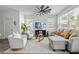 Bright living room with modern ceiling fan, large windows, neutral color palette, and lots of natural light at 3554 Bluebird Ct, Atlanta, GA 30331