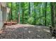 Spacious backyard with vibrant green trees and woodpile at 5215 Mainstreet Park Dr, Stone Mountain, GA 30088