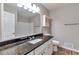Bathroom featuring granite countertop, tiled backsplash, white cabinets, and stylish fixtures at 5215 Mainstreet Park Dr, Stone Mountain, GA 30088