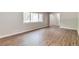 Bedroom featuring hardwood flooring, neutral paint, and a large window at 5215 Mainstreet Park Dr, Stone Mountain, GA 30088
