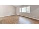 Bedroom featuring hardwood flooring, neutral paint, and a large window at 5215 Mainstreet Park Dr, Stone Mountain, GA 30088