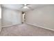 Bedroom with large closet space, plush carpet, and a ceiling fan at 5215 Mainstreet Park Dr, Stone Mountain, GA 30088