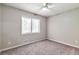 Light and airy bedroom with a large window, neutral carpet and ceiling fan at 5215 Mainstreet Park Dr, Stone Mountain, GA 30088