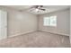 Bright bedroom features plush carpeting, ceiling fan, and a window allowing natural light at 5215 Mainstreet Park Dr, Stone Mountain, GA 30088
