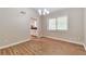 Bright dining room features wood-look floors, modern chandelier, and view of the kitchen at 5215 Mainstreet Park Dr, Stone Mountain, GA 30088