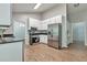 Updated kitchen features stainless steel appliances, white cabinets, and granite countertops at 5215 Mainstreet Park Dr, Stone Mountain, GA 30088