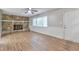 Cozy living room with stone fireplace, wood-look floors, and a view of the front yard at 5215 Mainstreet Park Dr, Stone Mountain, GA 30088