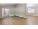 Living room with hardwood floors, high ceilings, and an open floor plan at 5215 Mainstreet Park Dr, Stone Mountain, GA 30088