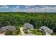 An aerial view showcases the homes nestled amidst a lush, dense forest at 217 Fernwood Pl, Woodstock, GA 30188