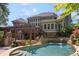 Spacious backyard features a beautiful pool and spa, stone patio and lush landscaping at 217 Fernwood Pl, Woodstock, GA 30188