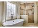 This primary bathroom features a standalone tub and a large glass enclosed shower at 217 Fernwood Pl, Woodstock, GA 30188