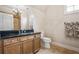 Bathroom with black granite counters, wood cabinets, tiled floors and stand-up shower at 217 Fernwood Pl, Woodstock, GA 30188