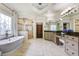 This large primary bathroom features a glass enclosed shower, standalone tub, and granite countertops at 217 Fernwood Pl, Woodstock, GA 30188