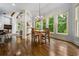 Dining area with natural light, hardwood floors, and a view of the surrounding greenery at 217 Fernwood Pl, Woodstock, GA 30188