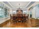 Formal dining room featuring hardwood floors, a large picture window, chandelier, and space for ten to dine at 217 Fernwood Pl, Woodstock, GA 30188