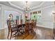 Formal dining room featuring hardwood floors, a large picture window, chandelier, and space for eight to dine at 217 Fernwood Pl, Woodstock, GA 30188