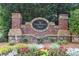 Stone sign with brick columns identifying the Fernwood Creek community at 217 Fernwood Pl, Woodstock, GA 30188