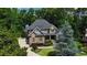Stately home with brick facade, manicured lawn, and lush landscaping evokes warmth and curb appeal at 217 Fernwood Pl, Woodstock, GA 30188