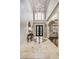 Stately foyer with soaring ceilings, detailed tile flooring, elegant lighting, and wrought iron double doors at 217 Fernwood Pl, Woodstock, GA 30188